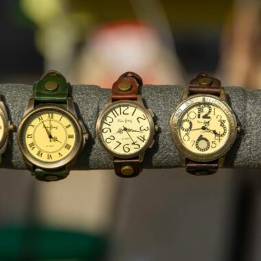 Assorted vintage watches with leather straps on a display rack.