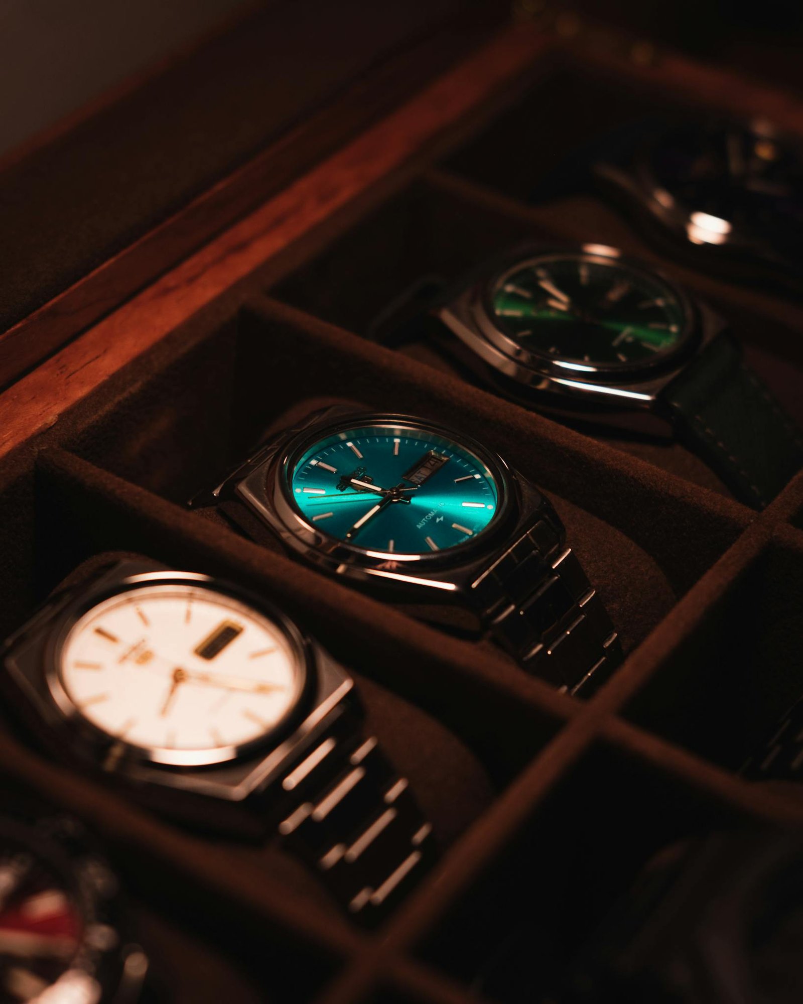 Showcase of elegant luxury watches in a display case with warm lighting.
